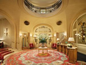 a lobby with a vase of flowers on a table at The Ritz London in London