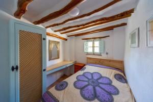 a bedroom with a bed with a purple flower on it at Casa Bonita Órgiva. in Órgiva