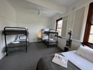 a bedroom with two bunk beds and a window at Hotel Concord in Sydney