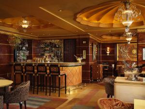 a bar in a restaurant with chairs and tables at The Ritz London in London