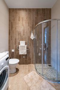 a bathroom with a shower and a toilet at Freedom avenue apartment by Polo Apartments in Kaunas +15 photos