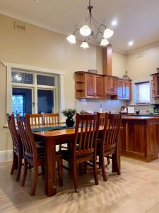 a kitchen with a dining room table and chairs at Aberdeen Cottage in Burra