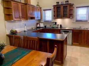 a kitchen with wooden cabinets and a wooden table with a tableablish at Aberdeen Cottage in Burra