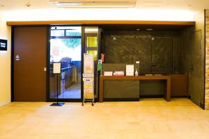 an entrance to an office with a desk and a glass door at Branchera Naha 1107 in Naha