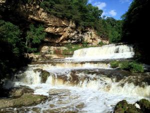 a group of falls on a river with trees at The Commerce, Trademark Collection by Wyndham in River Falls