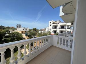 a balcony with white railing and a view of a city at Vila Sidi in Ksamil