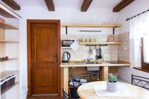a kitchen with a wooden door and a table at u Jaňola in Oščadnica +20 photos