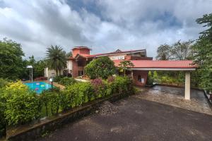a house with a swimming pool and a yard at SaffronStays Ananya, Karjat in Karjat