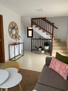 a living room with a couch and a staircase at Apartamentos Los Catorce, EL Hierro in Valverde