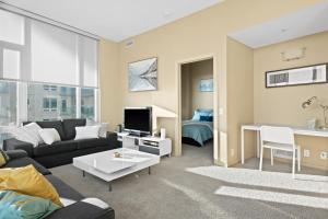 a living room with a couch and a table at Gorgeous Downtown Calgary Condos by GLOBALSTAY Free Parking in Calgary