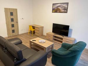 sala de estar con 2 sillas y TV en Grand apartments in the centre of Teplice en Teplice