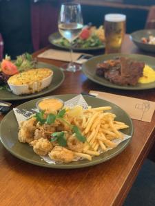 a table topped with plates of food and french fries at Hotel Concord in Sydney