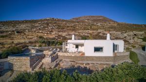 an aerial view of a house with a hill in the background at VILLA STELLA, LEFKES PAROS in Lefkes +26 photos