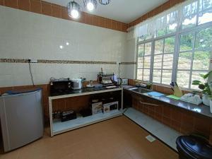 a kitchen with a sink and a refrigerator in it at Dream 2 in Cameron Highlands