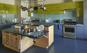 a large kitchen with blue cabinets and a sink at HI San Diego Downtown Hostel in San Diego