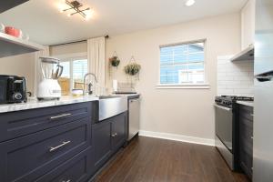 a kitchen with dark blue cabinets and a sink at Cozy Alamo Villa Game Tables Private Patio in San Antonio