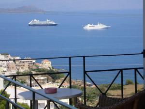 two cruise ships on the water in the ocean at Akrotiri Hotel in Chania Town