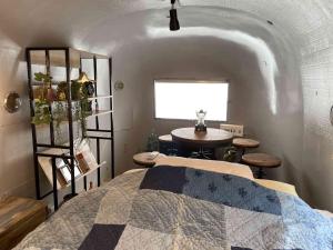a bedroom with a bed and a table and a window at TOCORO. Mt.Fuji The Airstream Kawaguchiko Station in Azagawa
