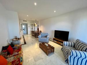 a living room with couches and a flat screen tv at Quiet & Spacious Apt @ Golf Course w/ Roof Terrace in San Roque