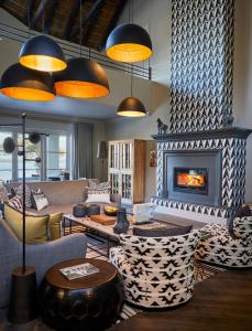 a living room with a couch and a fireplace at The Thatch House Hermanus in Hermanus