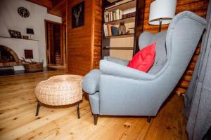 ein Wohnzimmer mit einem blauen Stuhl und einem roten Kissen in der Unterkunft Chata Růženka - Národní park České Švýcarsko in Arnoltice
