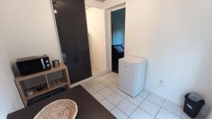 a small bathroom with a refrigerator and a microwave at Studio Privé Dijon in Dijon