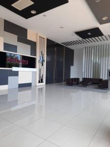 a large lobby with a white tile floor and a building at Dwiputra GetAway Homestay in Putrajaya