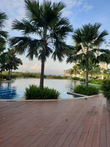 a group of palm trees next to a body of water at Dwiputra GetAway Homestay in Putrajaya