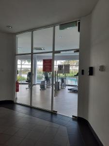 an empty lobby with glass doors in a building at Dwiputra GetAway Homestay in Putrajaya