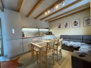 a kitchen and dining room with a table and chairs at Apartament u Beti in Opole