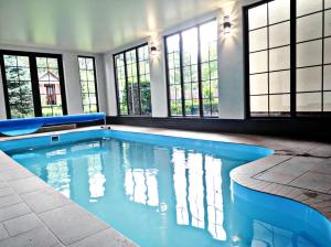 a swimming pool in a house with windows at Villa Diola in Kosiv