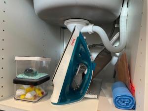 a blue and white appliance sitting on a shelf at Apartament u Beti in Opole