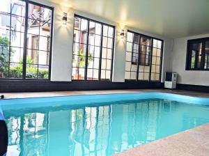 a swimming pool in a house with windows at Villa Diola in Kosiv