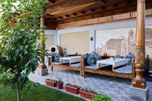 a room with two beds and a painting of a mosque at OLD TASHKENT Hotel & Spa in Tashkent