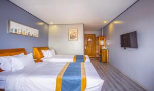 Postel nebo postele na pokoji v ubytování Junlan Hotel