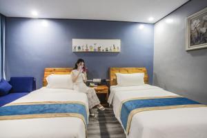 Postel nebo postele na pokoji v ubytování Junlan Hotel