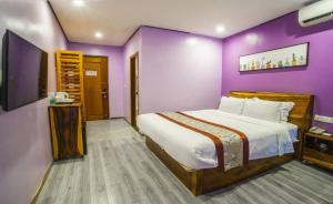 Postel nebo postele na pokoji v ubytování Junlan Hotel