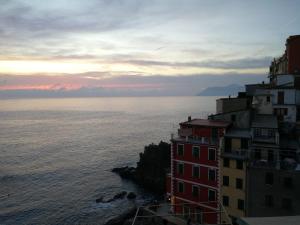 a building on the side of a cliff next to the ocean at CasaRiomaggiore "a few steps from the sea" in Riomaggiore