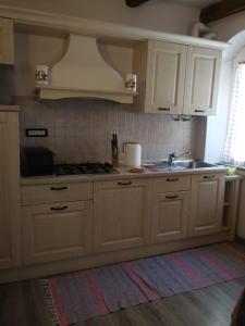 a kitchen with white cabinets and a sink at CasaRiomaggiore "a few steps from the sea" in Riomaggiore