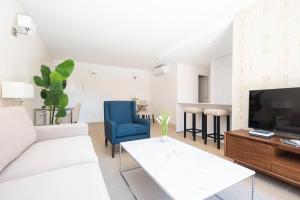 ein Wohnzimmer mit Sofa und Fernseher in der Unterkunft The Terraces Luxury Penthouses, 3D in Santa Cruz de Tenerife