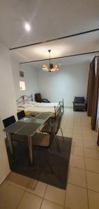 a room with a bed and a table and chairs at Lucas Apartment - Self check-in in Bratislava
