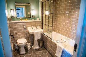 a bathroom with a sink and a toilet and a tub at Haighton Manor - Brunning and Price in Grimsargh