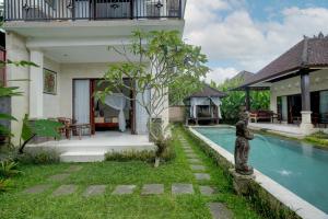 a villa with a swimming pool and a house at Queen Bisma Villa - 10 min walking to Ubud Center in Ubud
