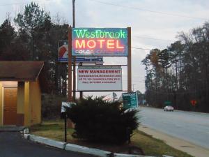 a sign for a motel on the side of a road at Westbrook Motel in Abbeville
