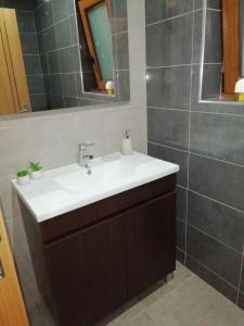 a bathroom with a sink and a mirror at Casa da Fonte em Prada, Vinhais in Vinhais