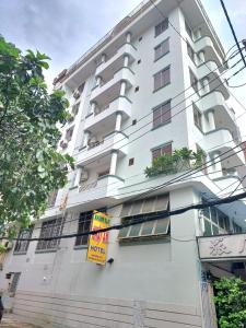 a white building with signs on the side of it at Nhật An Hotel in Ho Chi Minh City