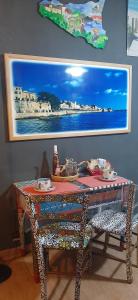 a table with chairs and a painting on the wall at OPEN SPACE in Augusta