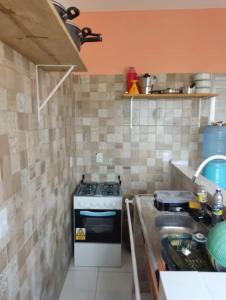 a kitchen with a stove top oven in a kitchen at APT. CAMINHO DE MOISÉS in Maragogi