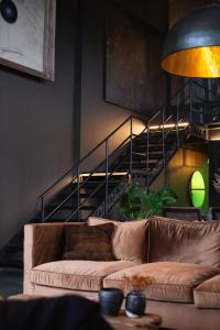 a living room with a couch and a staircase at The Bohemian Bali in Canggu