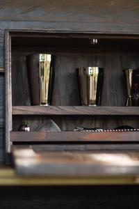a wooden shelf with four cups on it at The Bohemian Bali in Canggu